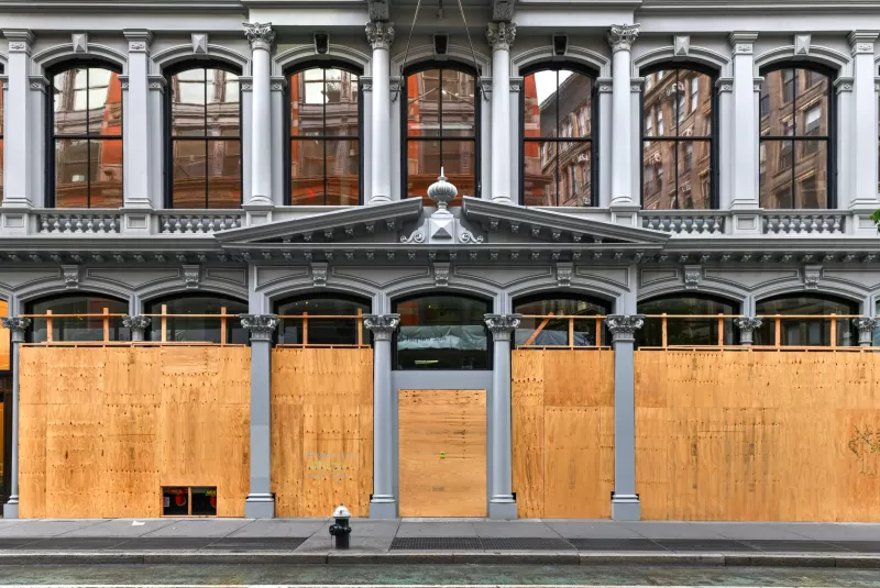 New York City, New York - June 11, 2020: Store closed during the COVID-19 pandemic, with boarded up windows to protect against looting as a result of anti-police brutality protests.